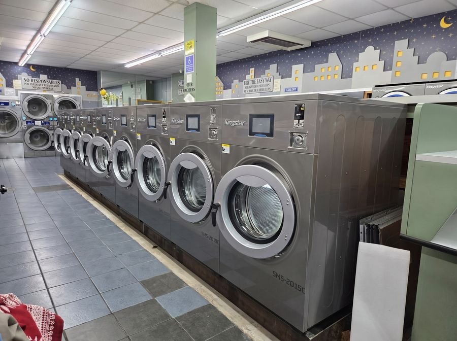 Row of newly installed Kingstar coin-operated washers in a laundromat