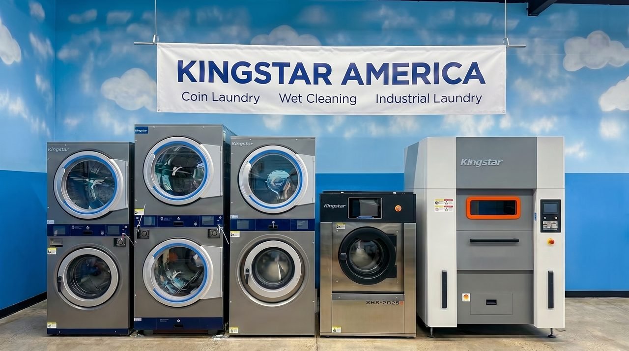 Kingstar America showroom display wall in Anaheim, California, with stacked washer-dryers, a soft-mount SHS-2025 washer-extractor and an industrial barrier washer beneath the Coin Laundry, Wet Cleaning and Industrial Laundry banner.